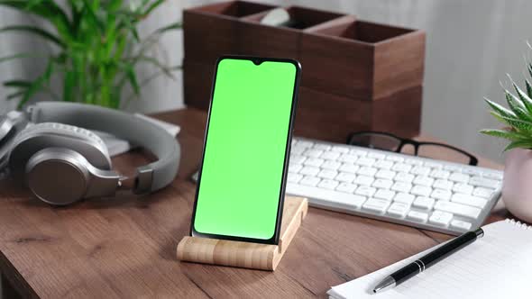 Smartphone with Green Screen on a Desk alt