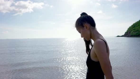 Cute Asian Woman in Black Swimsuit Walking Alone on a Sandbar Thailand alt