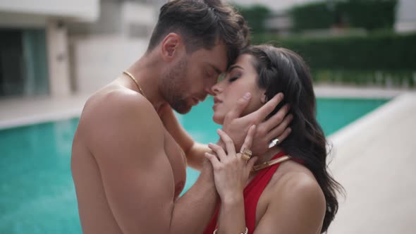 Beautiful Man and Girl Hugging By the Pool