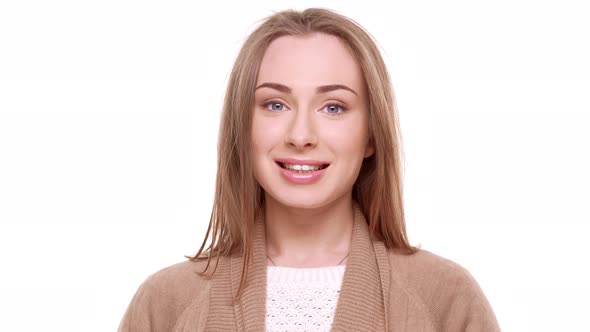 Confused Caucasian Young Female with Light Brown Hair Standing Shy on White Background alt
