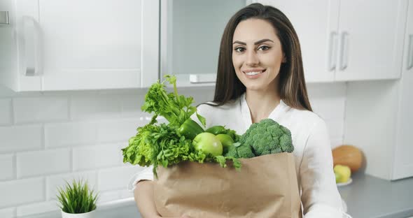 Woman Holding Bag with Green Vegetables