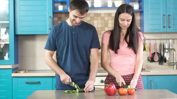 Husband and wife cheerfully prepare Breakfast in modern kitchen in a home alt