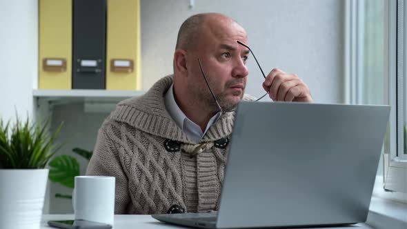 Middle Aged Businessman in Eyewear Working with Computer Remotely Sitting at Home or in Office alt