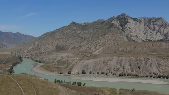 Mountains of Altai and blue river Katun under clear blue sky