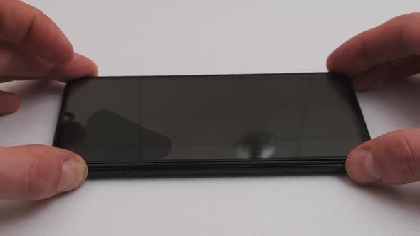 Sticking Protective Glass on the Smartphone Screen Change Cracked Safety Glass alt