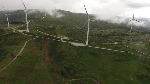Wind Turbines in Foggy Mountain alt