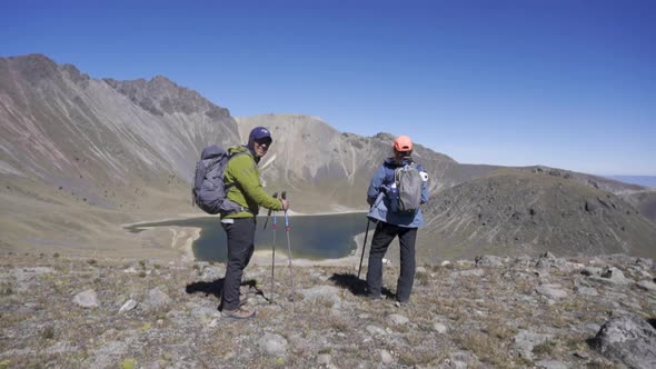 Couple Trekking on the natural landscape. Hiking man and woman alt