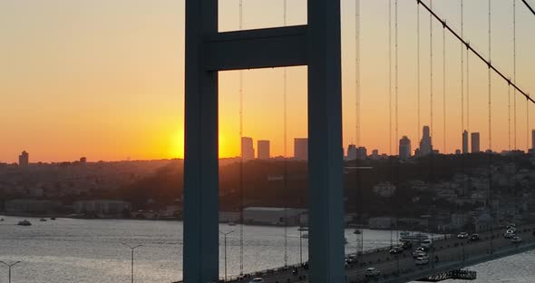 Istanbul Bosphorus Bridge and City Skyline in Background with Turkish Flag at Beautiful Sunset alt