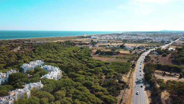 Panoramic View Over Praia Verde With Altura Town In Background In Portugal - aerial pullback alt