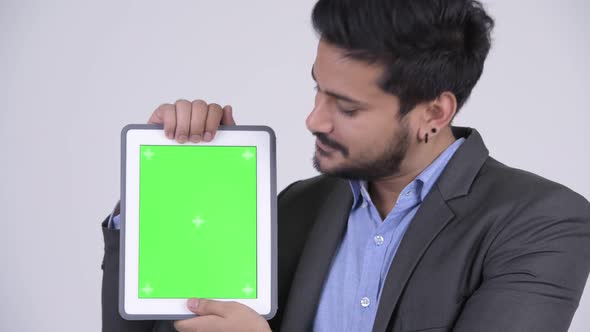 Young Happy Bearded Indian Businessman Showing Digital Tablet alt