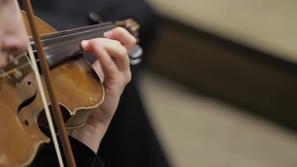  female violinist is playing violins during musical concert on classic theatre stage