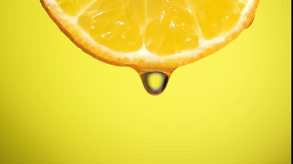 Water Dropping on an Orange Slice , Fruit for Diet and Healthy Food. Yellow Backgrond alt