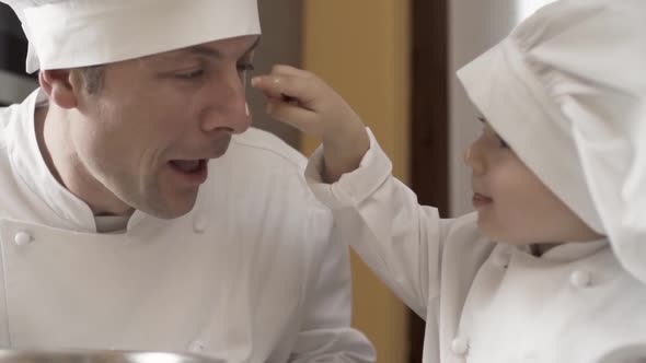 Lovely Closeup of Dad and Son Playing with Cake Batter