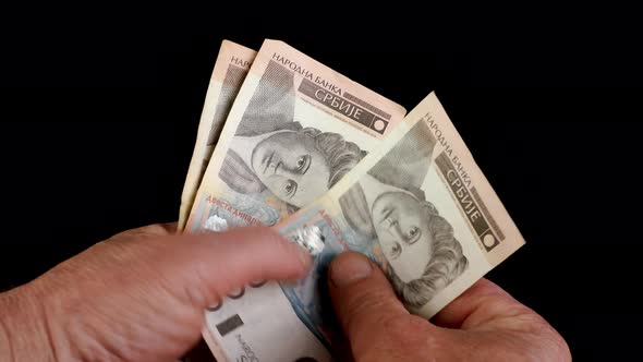 Hands counting stack cash Serbian dinar different cost, recalculation banknotes. alt