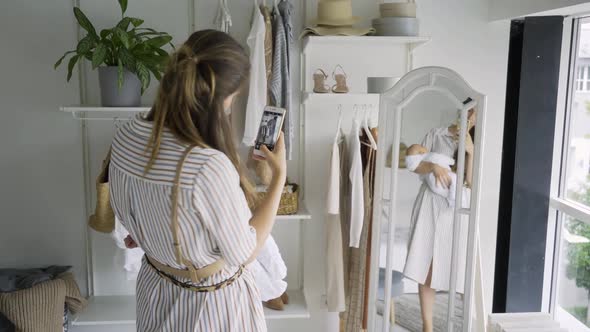 Fashionable Mother Holds Little Baby and Makes Photos