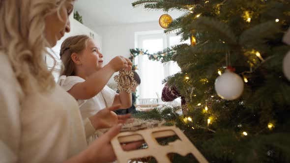 Family decorating home for Christmas. Shot with RED helium camera in 8K alt