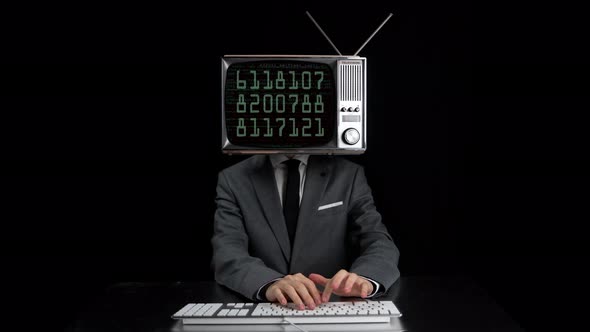 Man Typing TV Head Showing Numbers Screen alt