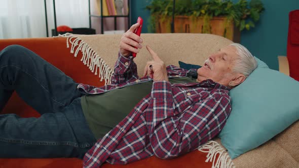 Senior Grandfather Use Mobile Cell Phone Online Shopping Found Out Great Big Win Celebrate at Home alt