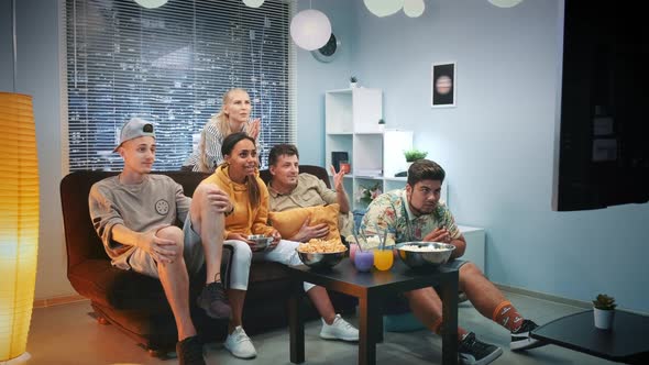 Excited Fans Watching Sports on TV and Spilling Popcorn When Team Scores alt