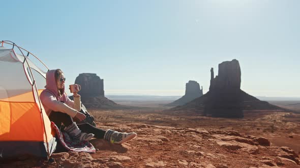 Woman Camping on Vacation in Canyon Enjoying New Day Contemplating Wilderness alt