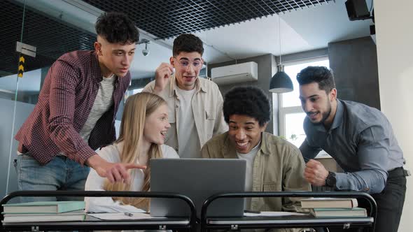 Focused Diverse Team Corporate Employees Colleagues in Office Looking at Laptop Screen Reading Good alt