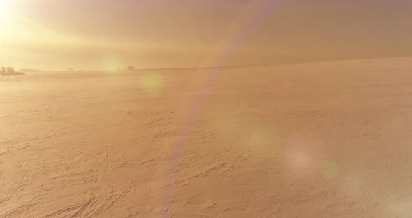 Aerial View of Cold Winter Landscape Arctic Field Trees Covered with Frost Snow Ice River and Sun alt