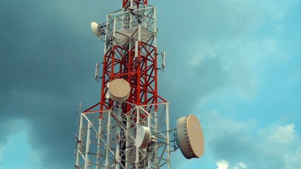 Large Telecommunication Tower Against Sky and Clouds in Background alt