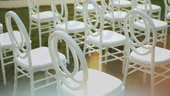 White Chairs for Guests at a Wedding Ceremony Slow Motion alt
