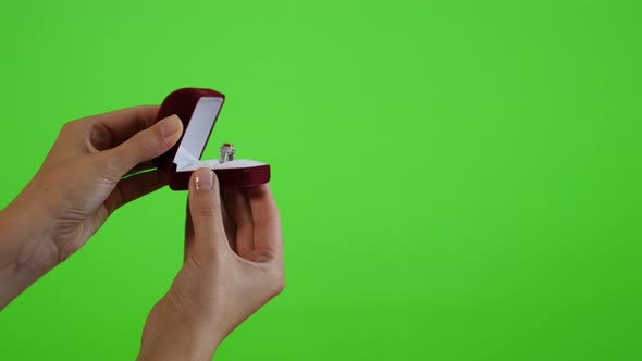 Displaying silver ring in the box greenscreen display 4K 2160p UltraHD footage - Woman holding box w alt