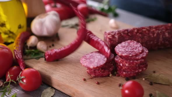 Sausage Slices on the Wooden Cutting Board at Domestic Kitchen alt
