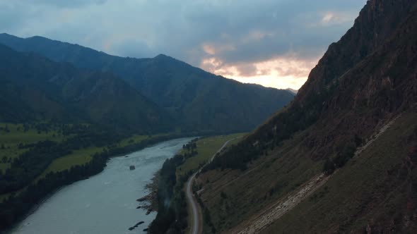 Katun river and road in valley of Altai at sunset time with dramatic sky