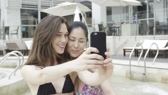 Women posing for selfie at luxury hotel