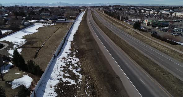 Colorado road with Rocky Mountains on the horizon alt