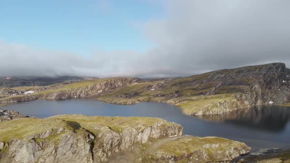 Glacial lake meltwater and rock hills, Hardangervidda, Norway subarctic, aerial alt