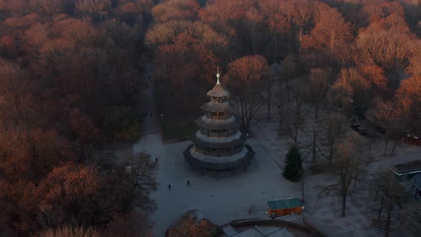 The Chinese Tower in Autumn in English Garden in Munich, Germany Surrounded By Beautiful Orange alt