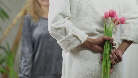 Bouquet of Beautiful Pink Tulips in Male African American Hands Behind Back alt