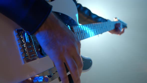 Close-up View of Rock Musician Mans Hands Masterfully Playing Electric Guitar alt