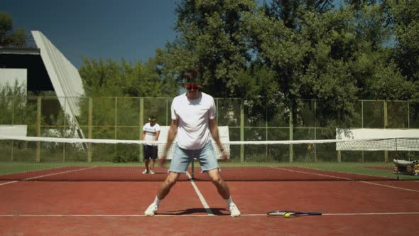 Tennis Player Warming Up Before Match on Court