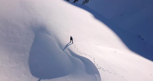 Aerial view of a lone hiker high up in the mountains