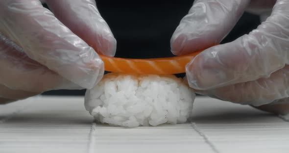 Chef Puts Salmon Slice To the Rice, Making the Nigiri in Slow Motion, Cooking Sushi Rolls, Asian alt