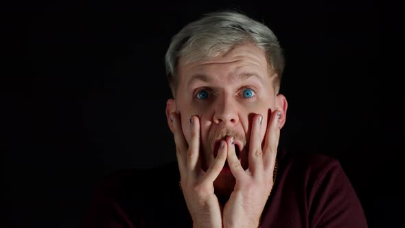 Shocked Surprised Stylish Man Feeling Excitement Looking at Camera and Holding Hands Near Face alt