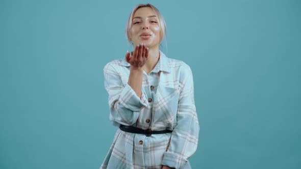 The Young Woman in Love and Smiling with Her Hand on Her Lips Shares Kisses and Smiles alt