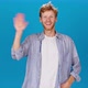 Cheerful Man in Shirt Waves Hello Introducing Himself - VideoHive Item for Sale