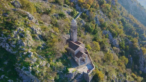 Aerial Shot of the Christian Church on a Way to the Top of the Mountain Where St alt