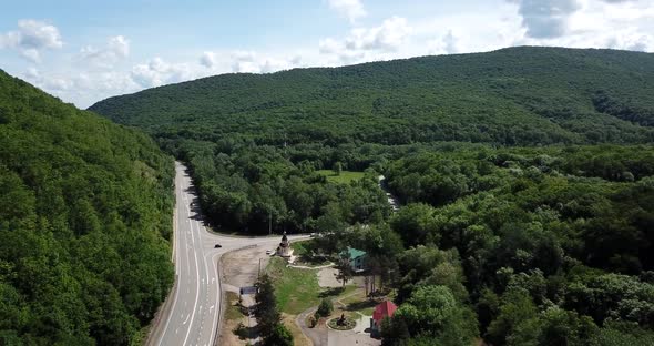 Aerial View of a Rural Highway Between Mountains alt