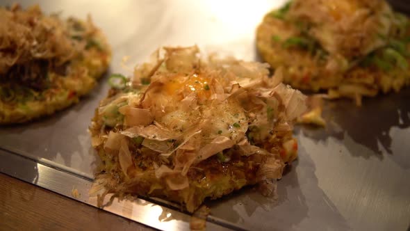 Okonomiyaki, Japanese traditional vegetable pancake being prepared