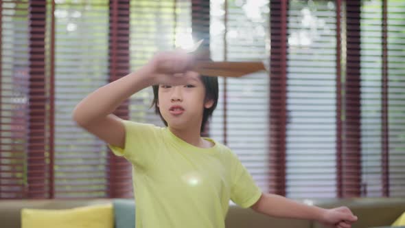 child boy play role,young boy playing as king hand hold paper sword smiling alt