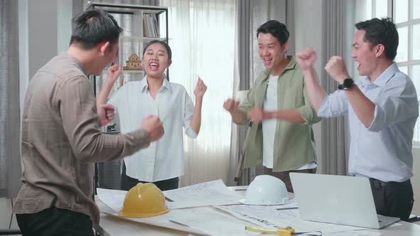 Group Of Asian Engineers Celebrating Finish Working At The Office alt