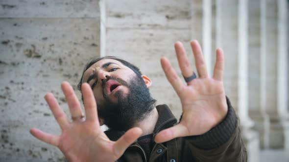 Young latin man making refusal gesture at camera.refusal, renunciation-outdoor alt