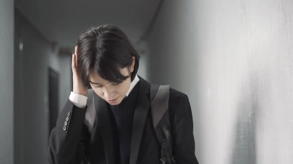 Shy Beautiful Teenage Schoolgirl Adjusting Clothes in Public School Corridor alt